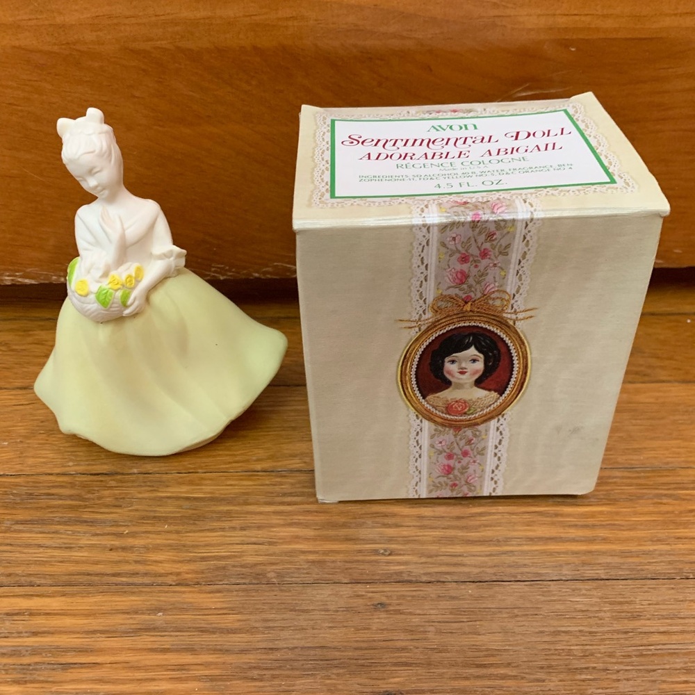 Vintage Avon perfume decanter. Loaded with yellow skirt and white top.